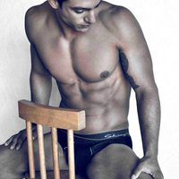 Joaquín Ferreira poses naked on a chair
