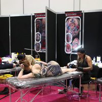 A girl with an Ewok dress getting a tattoo at the Star Wars Celebration 2016
