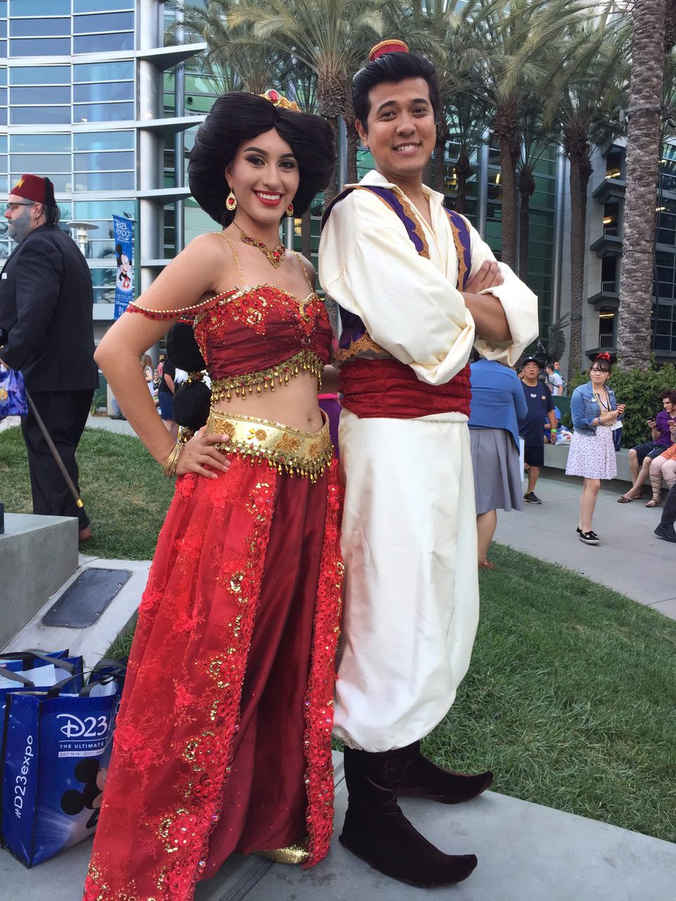 Two fans dressed up like Jasmine and Aladdin