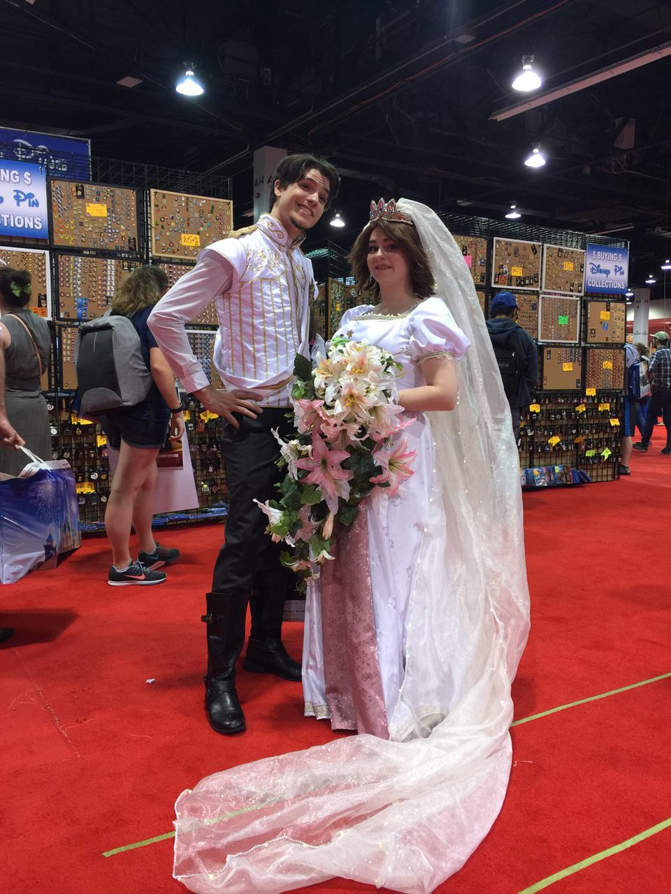 Couple dressed up like Rapunzel and Flynn in the D23